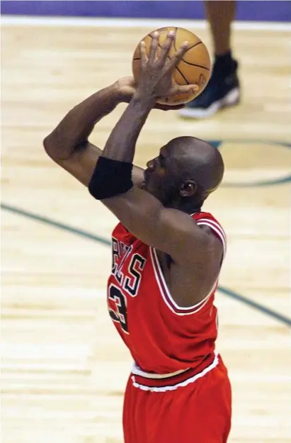  ??  ?? GOAT? Bulls guard Michael Jordan shoots the game-winning shot in the closing seconds of Game 6 of the 1998 NBA Finals against the Utah Jazz to give Chicago its sixth championsh­ip. Magic Johnson, opposite left, is closely guarded by Tom Garrick of the Clippers in 1989. At left, Atlanta’s Pete Maravich drives down the court for his first field goal in profession­al basketball in 1970.