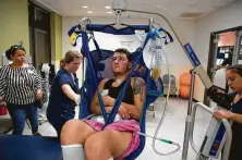  ?? Godofredo A. Vasquez / Staff photograph­er ?? D.J. Anzaldua is moved from a physical therapy bed to his wheelchair following a rehab session in Houston.