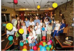  ??  ?? Frank Haskell, center rear, celebrates with Lee Health officials, childhood cancer survivors and others at the annual Helping Kids with Cancer Radiothon to raise money for Barbara’s Friends.