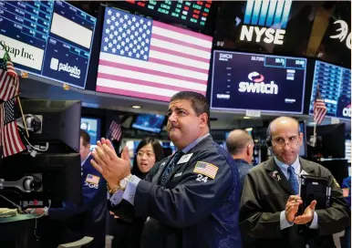  ?? (Brendan McDermid/Reuters) ?? TRADERS REACT on the floor of the New York Stock Exchange last Friday. The question for equity investors is now: Was September just a catch-up period for the lagging, cyclical sectors, or can an economic lift support a sustained run?