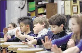  ?? STAN CARROLL/THE COMMERCIAL APPEAL ?? Fourth-grader Zach Parris (center) plays a tubano during music class at the University of Memphis Campus School last month. Christian Brothers University looks to put a high school following Campus School’s model at Midtown’s Crosstown Concourse.