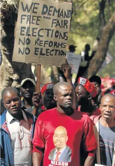  ?? Picture: PHILIMON BULAWAYO/REUTERS ?? LEVEL PLAYING FIELD: Members of Zimbabwe’s opposition parties hold placards in a march to the Zimbabwe Electoral Commission to demand reforms to ensure credible, free and fair elections