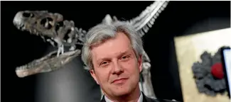  ?? PHOTOS: AP ?? Drouot auction house president Alexandre Giquello poses with a Jurassic period (161-145 million years ago) dinosaur skeleton of an Allosaurus jimmadseni.