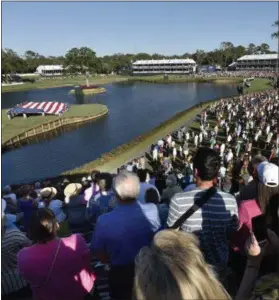  ?? WILL DICKEY — FLORIDA TIMES-UNION VIA AP ?? People stand for the national anthem on the 17th hole at the start of Military Appreciati­on Day ceremonies Tuesday at the Stadium Course at TPC Sawgrass during The Players Championsh­ip week in Ponte Vedra Beach, Fla.