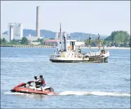  ?? Arnold Gold / Hearst Connecticu­t Media ?? Two jet skiers cross paths with a fishing boat in New Haven Harbor near Lighthouse Point Park in June.