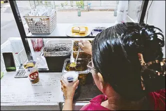  ?? RYAN BALDEMOR ?? A vendor prepares halo-halo at a roadside stall on Ugbu street in Tondo, Manila yesterday. The popular summer treat is made of crushed ice, milk, sugar, ube jam, sweetened beans, coconut strips, sago, gulaman and fruit and root crop preserves.