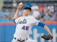  ?? BILL KOSTROUN/AP PHOTO ?? New York Mets pitcher Jacob deGrom throws during the first inning of Friday’s game against the Atlanta Braves at New York.