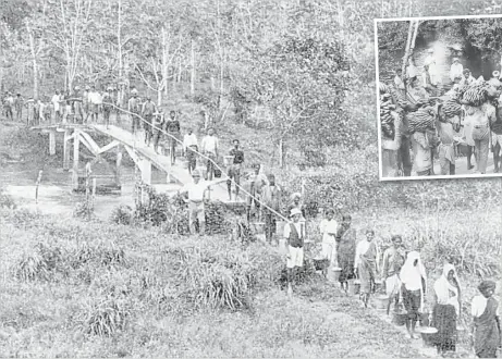  ?? Picture:www. girmit.org (Courtesy of Fiji Museum) ?? Labourers return from work at a rubber plantation.