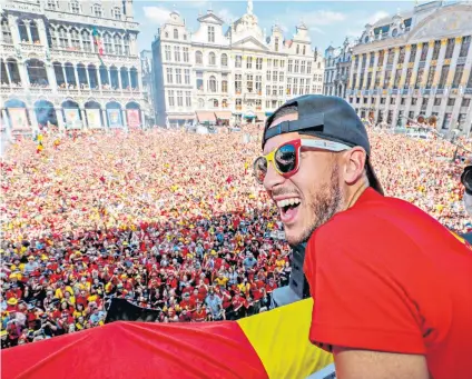  ??  ?? Coming home: Eden Hazard enjoys the acclaim of the Belgium fans in Brussels after the squad’s return from the World Cup