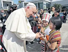  ??  ?? Pope Francis was greeted by local children on arrival at Rangoon Internatio­nal Airport