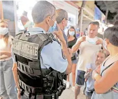  ?? — AFP photo ?? French gendarmes patrol in Argeles-sur-Mer’s streets, southern France, to control the mandatory wearing of masks during Covid-19 (novel coronaviru­s) pandemic.