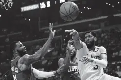  ??  ?? LAKERS forward Anthony Davis (3) passes the ball ariybd LA Clippers forward Marcus Morris Sr. (31) in the first half at Staples Center in Los Angeles, California, US, March 8, 2020. Kirby Lee, USA TODAY Sports/Reuters