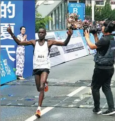  ?? PROVIDED TO CHINA DAILY ?? A Kenyan runner from the Tao Camp crosses the finishing line at a marathon held in Liupanshui, Guizhou province.