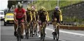  ?? THIBAULT CAMUS / AP ?? A man pedals with Jumbo Visma cycling team riders during a training near Bilbao, Spain, on Thursday. The Tour de France starts Saturday in Bilbao.