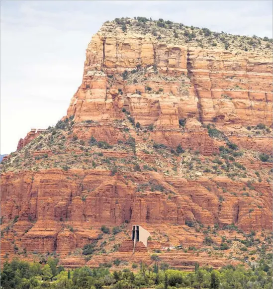  ?? Ricardo DeAratanha Los Angeles Times ?? CHAPEL OF THE HOLY CROSS is built into the red rocks of Sedona, Ariz. For a peaceful visit, stick to the area’s natural wonders and avoid uptown.