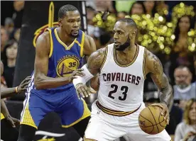  ?? TONY DEJAK / AP FILE ?? Kevin Durant (left) and the champion Warriors will host LeBron James and the runnerup Cavaliers on Christmas Day. The teams will play Jan. 15 in Cleveland.