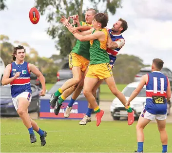  ?? ?? Crashing in mid-air are Garfield’s Sean Marsh and Jett Pickering and Bunyip’s Curtis Jenkin. Photograph­s by AMANDA EMARY.