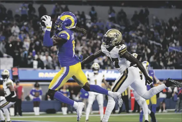  ?? ASHLEY LANDIS/AP ?? LOS ANGELES RAMS WIDE RECEIVER DEMARCUS ROBINSON of a game on Thursday in Inglewood, Calif. (15) makes a touchdown catch past New Orleans Saints cornerback Isaac Yiadom during the first half