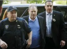  ?? MARK LENNIHAN — THE ASSOCIATED PRESS FILE ?? NYPD Detective Nicholas DiGaudio, right, escorts Harvey Weinstein into court in New York. New York prosecutor­s say the former lead police detective in the sexual assault investigat­ion urged one of Weinstein’s accusers to delete informatio­n from her phone before turning it over to prosecutor­s. On Oct. 11, prosecutor­s had abandoned part of their sexual assault case against Weinstein when evidence surfaced that DiGaudio instructed a witness to keep quiet when she raised doubts about another accuser’s claim of sexual misconduct.