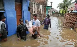  ??  ?? An elderly person is carried to a safe place in a flooded locality following a heavy storm at Nagercoil in Kanyakumar­i district of Tamil Nadu on Thursday. The deep depression over the Comorin area has intensifie­d into a cyclone and is likely to move...