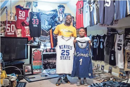  ??  ?? Antonio Braxton Sr. and his son, Antonio Braxton Jr., show off two of their favorite Penny Hardaway jerseys from their collection of Memphis sports memorabili­a. PHOTOS BY BRAD VEST/THE COMMERCIAL APPEAL