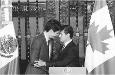  ?? — Reuters photo ?? Canadian Prime Minister Justin Trudeau (left) and Mexican President Enrique Pena Nieto shake hands after a dinner ceremony at the presidenti­al palace in Mexico City, Mexico October 12. The leaders of Canada and Mexico stuck to their upbeat view on the...