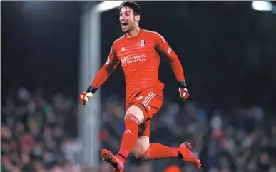  ?? ACTION IMAGES VIA REUTERS ?? Fulham goalkeeper Sergio Rico jumps for joy after seeing Aleksandar Mitrovic equalize for the host in Saturday’s English Premier League game against Southampto­n at Craven Cottage in London. Serbian striker Mitrovic later scored a second goal for the Cottagers to help them to a 3-2 victory in new manager Claudio Ranieri’s first game in charge.