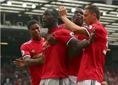  ?? — AP ?? Manchester United’s Romelu Lukaku celebrates his goal of the game with teammates during a league match at Old Trafford.