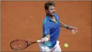  ?? MICHEL EULER — THE ASSOCIATED PRESS ?? Switzerlan­d’s Stan Wawrinka returns the ball to Ukraine’s Alexandr Dolgopolov during their second round match of the French Open Thursday in Paris.