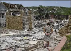  ?? AP ?? An elderly woman walks next to a building damaged by an overnight missile strike in Sloviansk, Ukraine, Wednesday.