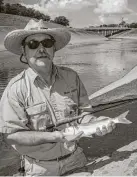  ??  ?? Fly-fisher and fishing guide/instructor Mark Marmon fights an acrobatic striped mullet that slammed a fly worked in the concrete-lined section of Houston’s Brays Bayou. Marmon has landed 18 species of fish from the city’s urban waterways.