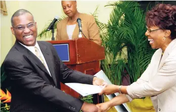  ?? FILE ?? Dr Claudette Cooke, vice-president of human resource management of Jamaica Broilers Group, presents the Fair Play Award to Gleaner columnist Ian Boyne for his interview programme, ‘Profile’, at the Hilton Kingston Hotel in New Kingston on September 20,...