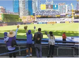  ?? KIRK KENNEY U-T ?? Fans try to get the attention of Dodgers pitcher Julio Urias in an attempt to get a ball thrown to them during batting practice Saturday night at Petco Park.