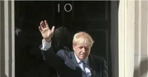  ?? Isabel Infantes/ AFP/ Getty Images ?? Britain’s new prime minister, Boris Johnson, waves outside 10 Downing Street in London on July 24.