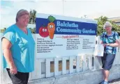  ??  ?? Wellsuppor­ted . . . Balclutha Community Garden committee members Robyn Bell (left) and Beatrice Pratt by the sponsorshi­p board. Beatrice is holding the garden’s Trustpower award.