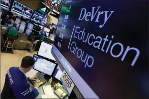  ?? The Associated Press ?? FOR-PROFIT COLLEGES: In this Jan. 27, 2016, file photo, Specialist Neil Gallagher works at the post that handles DeVry Education Group on the floor of the New York Stock Exchange. A little-known venture capitalist is on the verge of acquiring one of the country’s biggest for-profit colleges, a transactio­n that would put him in control of a troubled national chain vastly larger than the tiny California school he currently owns.