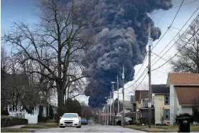  ?? (AP Photo/gene J. Puskar/file) ?? A black plume rises over East Palestine, Ohio, on Feb. 6 as a result of a controlled detonation of a portion of derailed Norfolk Southern trains. The Biden administra­tion is initiating a formal evaluation of risks posed by vinyl chloride, the cancer-causing chemical that burned in a towering plume of toxic black smoke following a fiery train derailment earlier this year in eastern Ohio.