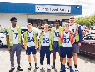  ?? CONTRIBUTE­D ?? Members of the Hamilton High School’s football team volunteere­d Wednesday at the the Village Food Pantry in New Miami. Hassan Robertson, Zach Waller, Caden Brock, Lanny Ash, Noah Waller and Kaleb Taylor.