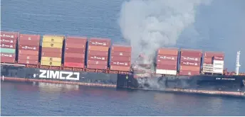  ?? — AFP photo ?? In this photo released by the Canadian Coast Guard and received by AFP, smoke is seen rising from the side of the container ship Zim Kingston off Canada’s Pacific coast.