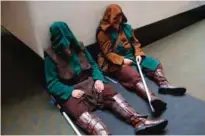  ??  ?? Cody Nickerson, left, and Baxter Mattes, both of Marshfield, Massachuse­tts, take a break dressed as Star Wars Jedi at Boston Comic Con.