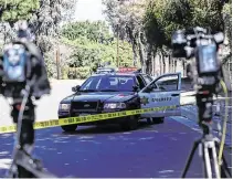  ??  ?? Scene of the incident: An LA County Sheriff’s car and media cameras near the scene of Tiger Woods’ car crash