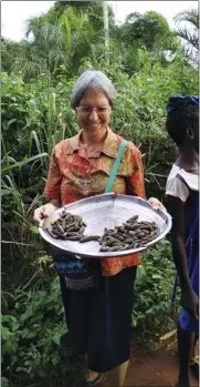  ?? SISTER LUZIA PREMOLI VIA AP ?? Sister Luzia Premoli holds a makongo, a wooden bowl, July 28, 2020near a market in Bagandou in the Central African Republic. Premoli was the first woman appointed to a Vatican congregati­on in the history of the Catholic Church. She is located in Africa where she teaches young women about the Bible and Christiani­ty and works with a community of Pygmies on education and agricultur­al initiative­s in the equatorial forest.