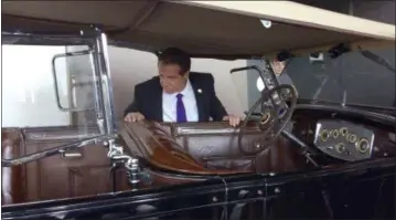  ?? ANNA GROENWALD — ASSOCIATED PRESS ?? New York Gov. Andrew Cuomo, shown Tuesday at the New York State Museum in Albany, looks over the Packard Phaeton used by Franklin D. Roosevelt when he was governor of New York.