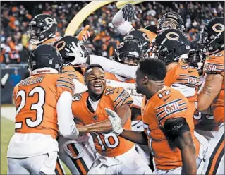  ?? BRIAN CASSELLA/ CHICAGO TRIBUNE PHOTOS ?? One of the lasting images of the 2018 season was this celebratio­n after an Eddie Jackson pick-6 — with wide receiver Taylor Gabriel in the middle of it all — en route to a 25-20 victory over the Vikings on Nov. 18 at Soldier Field.