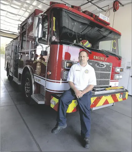  ??  ?? ABOVE: U.S. Army Yuma Proving Ground Assistant Fire Chief Daniel Manning sits on the front bumper of Engine 2 inside the base firehouse Thursday.