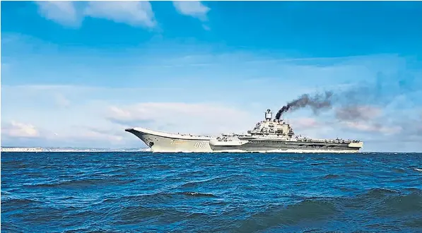  ??  ?? Belching black smoke, the Admiral Kuznetsov, passes off the coast of Dover in Kent, yesterday morning. Despite its problems, it is thought to be heading to Syria where its aircraft will join an assault on rebels in Aleppo