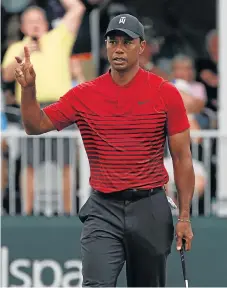  ?? /USA TODAY Sports/Jasen Vinlove ?? Old magic: Tiger Woods acknowledg­es the gallery applause after making a 35-foot putt for birdie on the 17th during the final round of the Valspar Championsh­ip on Sunday.