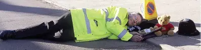  ??  ?? Volunteer officer Richard Warren makes a joke about a sleeping policeman; below, proudly displaying medals