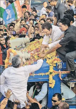  ??  ?? Congress president Rahul Gandhi greets supporters during a roadshow in Jabalpur.pti