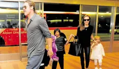  ?? —REUTERS ?? A HAPPIER TIME Hollywood actors Brad Pitt (left) and Angelina Jolie arrive with their children Knox (beside Pitt), Vivienne (right) and Pax (center) at Haneda internatio­nal airport in Tokyo on July 28, 2013.